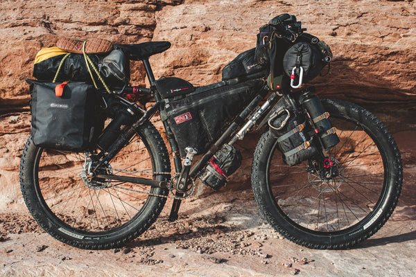 Mountainbike with bikepacking bags against a wall