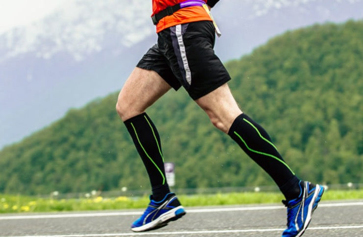 man running outside in compression socks