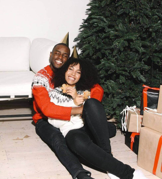image of couple in front of christmas tree