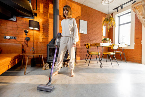 girl vacuuming the floor barefoot