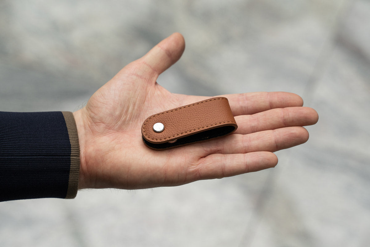 The minimalistic and compact key organizer on a palm of a hand