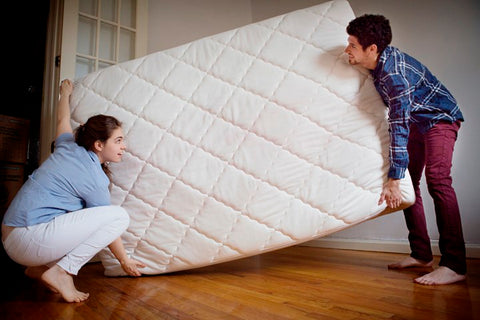 Couple replacing mattress