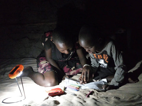 Children Reading With Solar Light