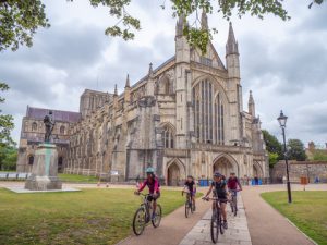 Electric bikes in front of Winchester Cathedral 