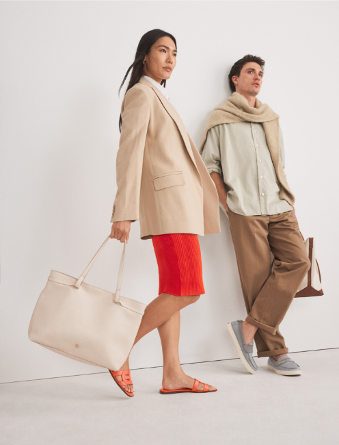 Man and woman holding tote bags