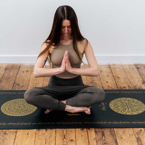 Rings of Power Yogamatte im Sitzen mit Namaste-Händen