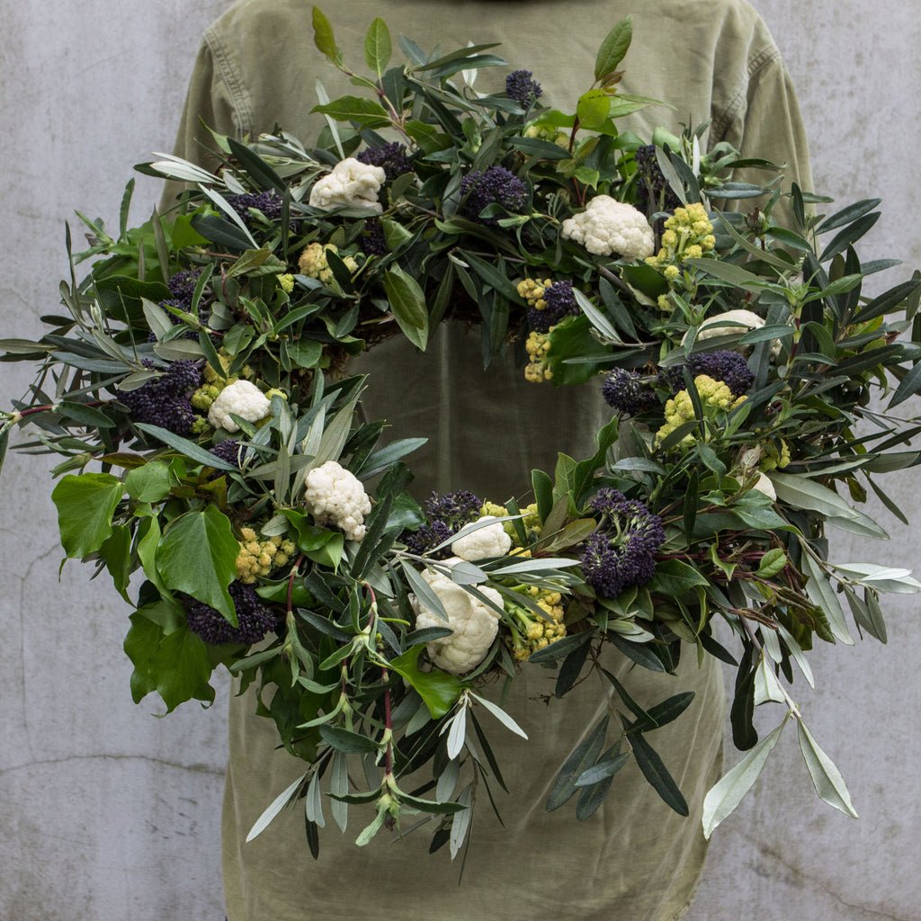 Catherine holding large foliage and cauliflower wreath