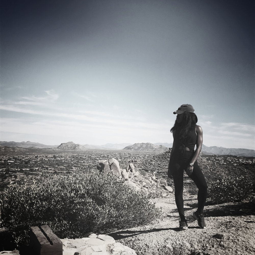 Our founder, Alana, wearing the 'higher thoughts' tank, while feeling victorious after completing a challenging hike in Arizona -- all due to the strength of her mind.