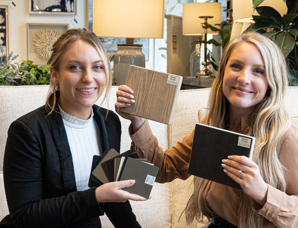 Two girls holding materials for customizable dining furniture