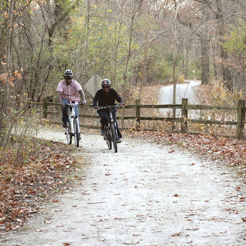 Two Men Riding E Bike on the Road