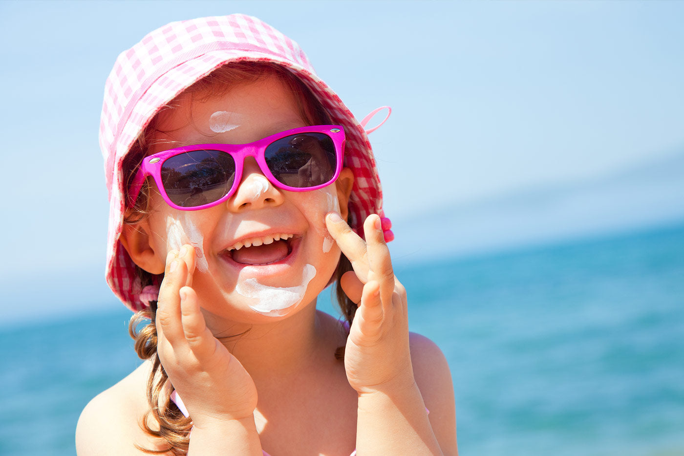 Child using sunscreen