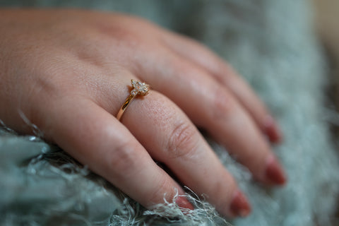 a hand with a marquise cut diamond ring