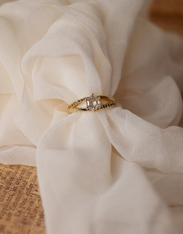 a salt and pepper hexagon ring in yellow gold with black diamonds