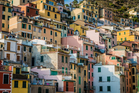 an image of unique and colorful buildings in a seaside village, like one in Cinque Terre.