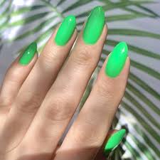 Green Coloured Low-Tox Nail Polish painted on nails with hand in view