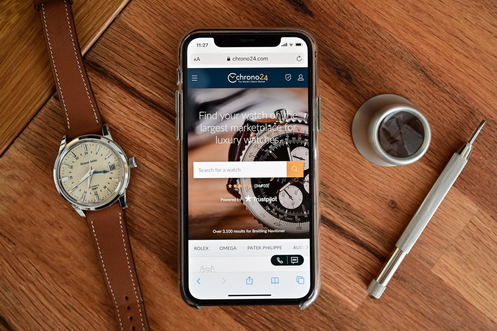 watch and phone on table with chrono24 app open