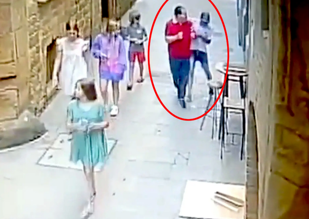 watch theif removing timepiece from wrist of tourist