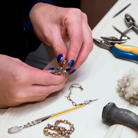 Crafting a detailed jewelry piece, focusing on hand movements