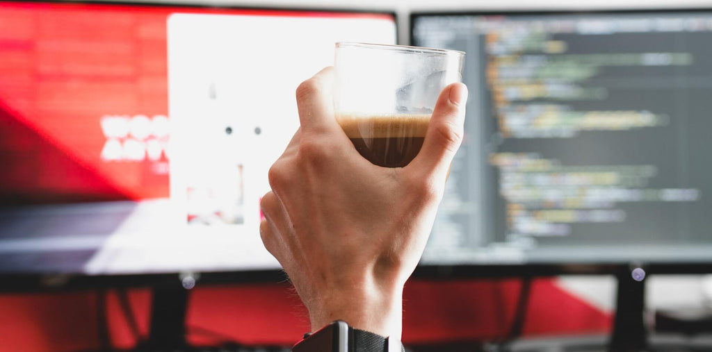  a man holds a cup of coffee