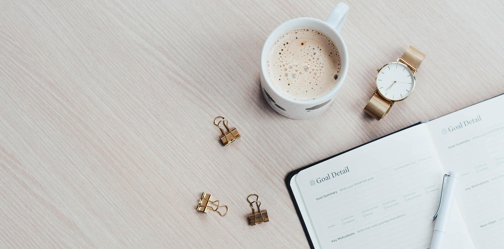 Planner and a cup of coffee on the table