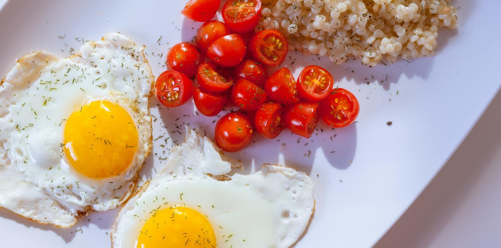 fried eggs tomatoes and kale for morning breakfast