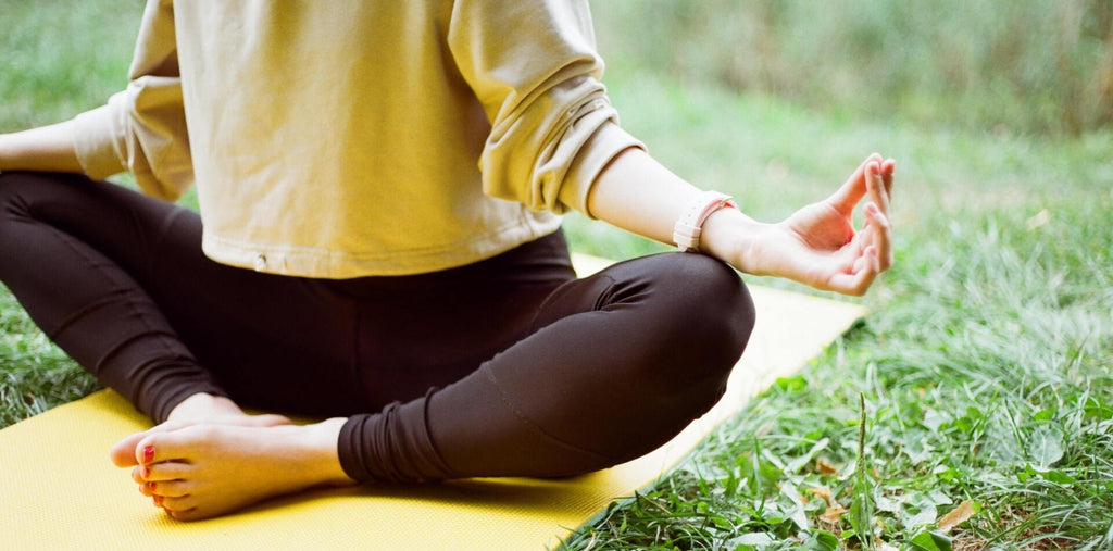 Meditating women on a yoga mat