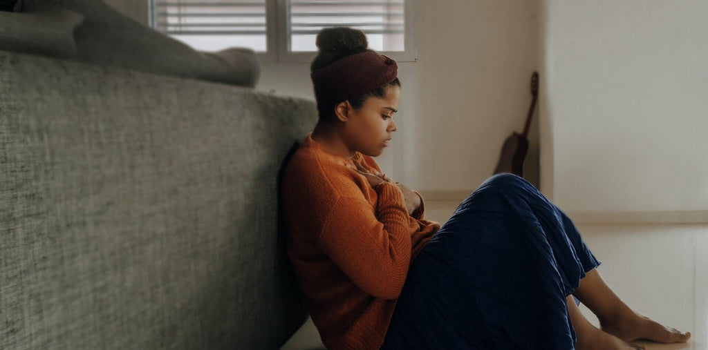 A stressed woman sitting in her living room