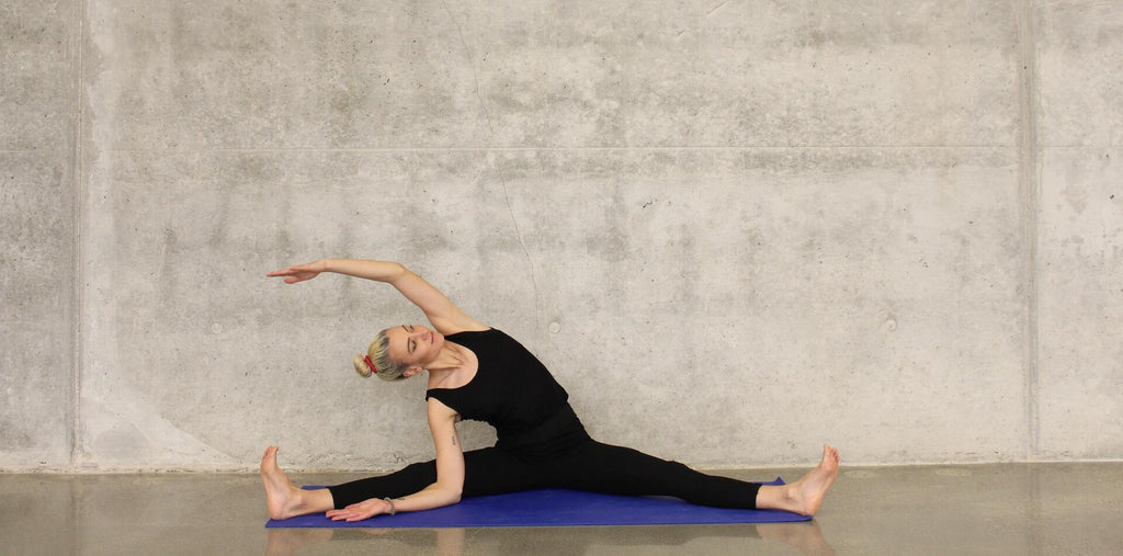 A woman stretching at the gym