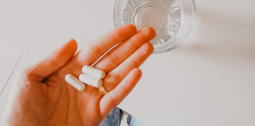 A few collagen capsules in a palm