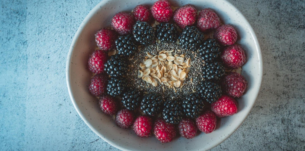 red and black berries on white plate