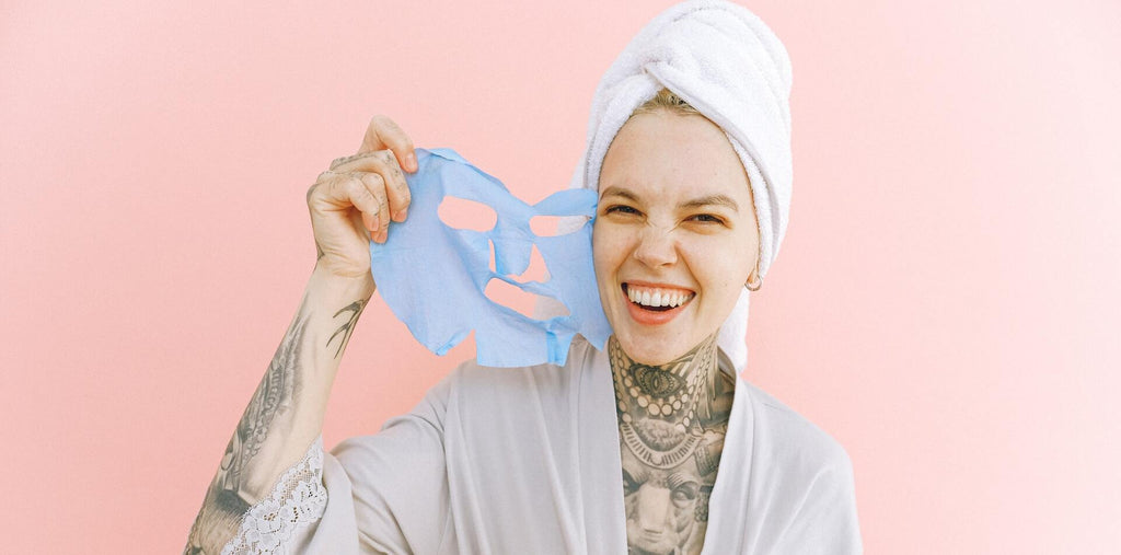 Happy woman removing face mask after taking bath