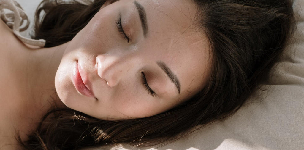 A woman sleeping tight after taking melatonin supplements