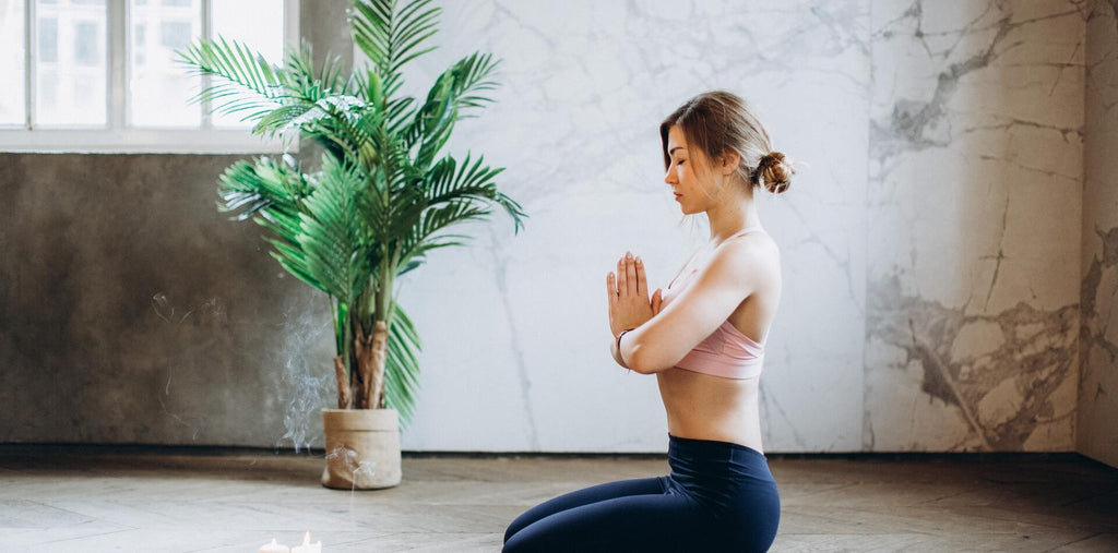 Woman meditating in a gym