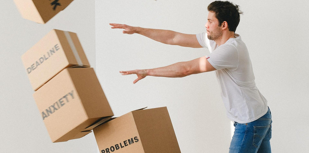 Man falling carton boxes with negative words
