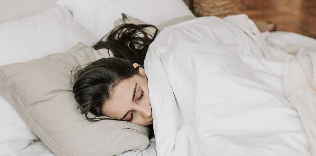 A woman sleeping tight after taking melatonin supplements