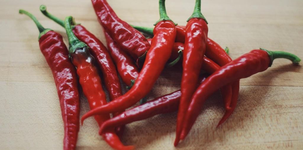  a few cayenne peppers on the table