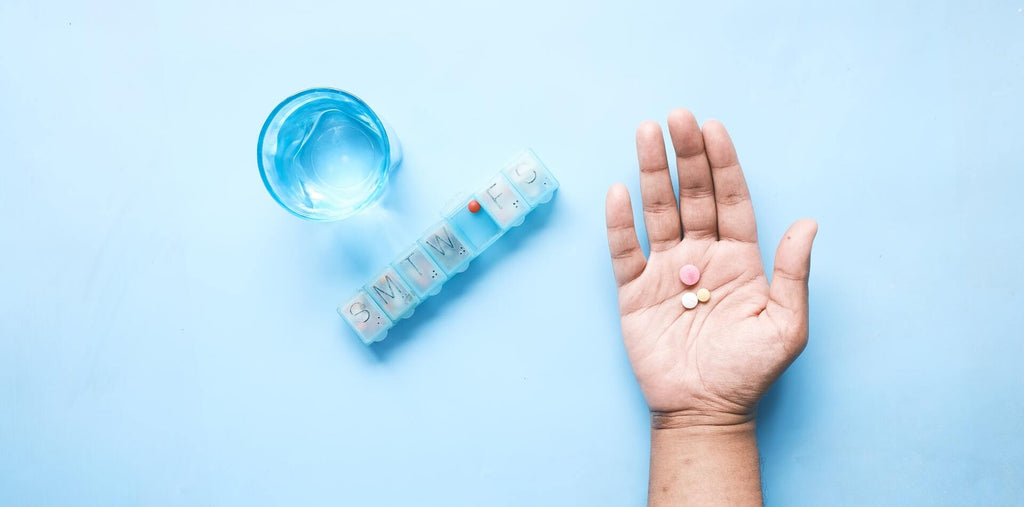 Person with a pill-box, filled with supplements