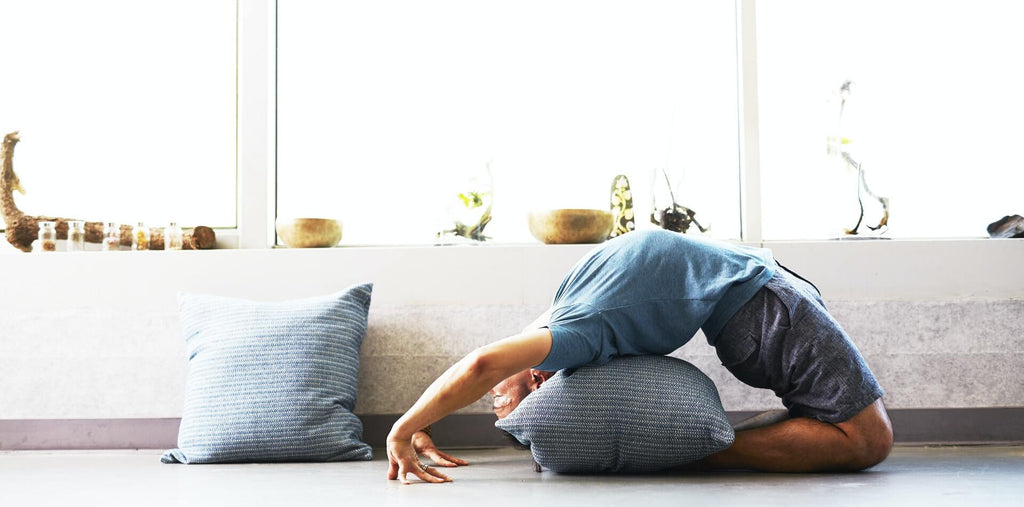 Man practicing yoga at home