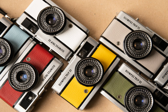 Different colours of Olympus Trip cameras