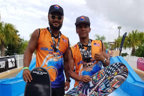 jon wavemaker and aquaflowboard teammate showing off medals won at flowtour at solara resort in orlando florida. wearing thank the weavekaer black ecofriendly hat with thank the wavemaker logo