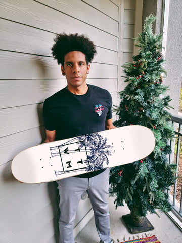 founder of thank the wavemaker holding a ttwm house skateboard. 