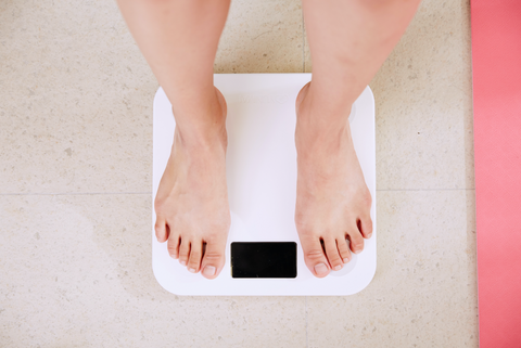 woman standing on a white scale