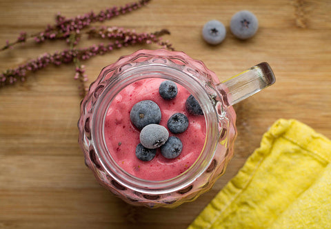 smoothie with blueberries on a wooden table