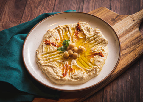 bowl of red pepper hummus with olive oil