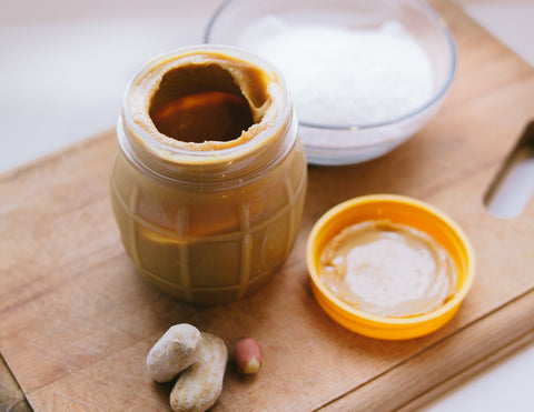 all natural penut butter and salt on a wooden cutting board