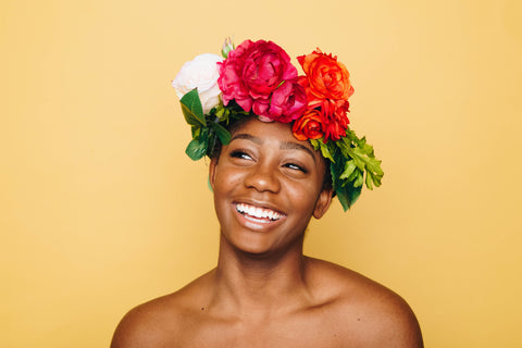 woman smiling with flowers on her head