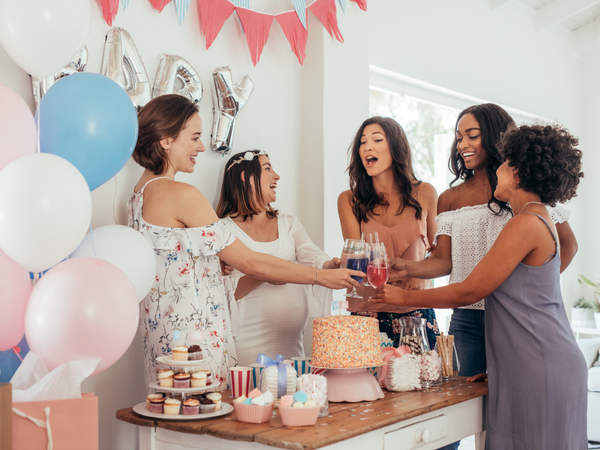 Woman surrounded by baby shower food
