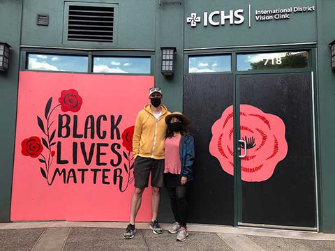 Misha Zadeh and Ben Graham in front of murals they painted in support of Black Lives Matter in front of the International Community Health Services Vision Clinic in Seattle's Chinatown International District.