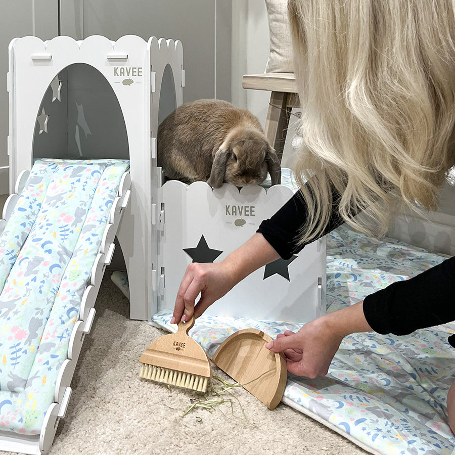 Woman cleaning a rabbit living area with Kavee dustpan and brush