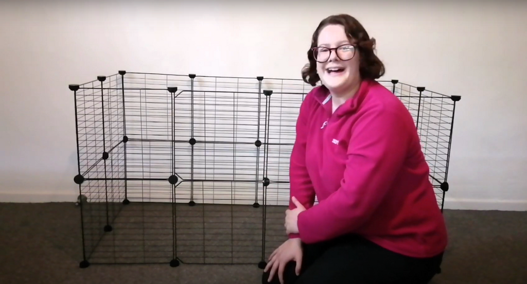 Woman next to an assembled Kavee C&C cage for rabbits